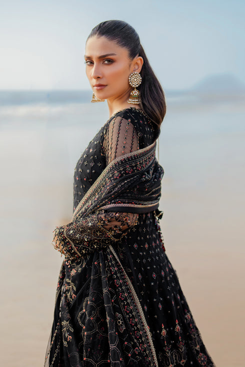 Back view of NAQSHI Blain frock featuring heavy handmade tassels hanging from back, embroidered red‑hued geometric border, and minimal lace finish.